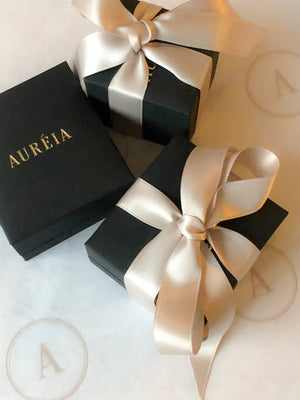 Auréia Fine Jewellery packaging - charcoal grey box with blush pink ribbon